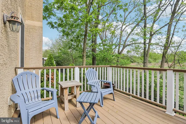 a view of balcony with wooden floor and outdoor seating