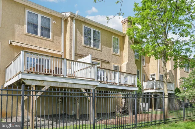 a view of a house with a wooden deck