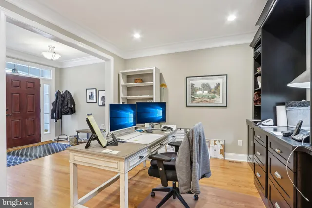 a view of a workspace with furniture and a flat screen tv
