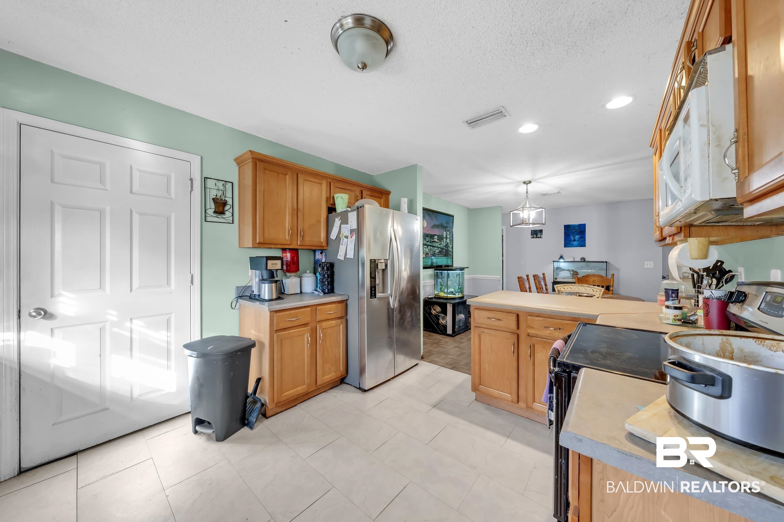 16603 Vanilla Drive Foley, AL 36535 - Photo 10 of 19 Kitchen featuring appliances with stainless steel finishes, light countertops, hanging light fixtures, recessed lighting, and a peninsula