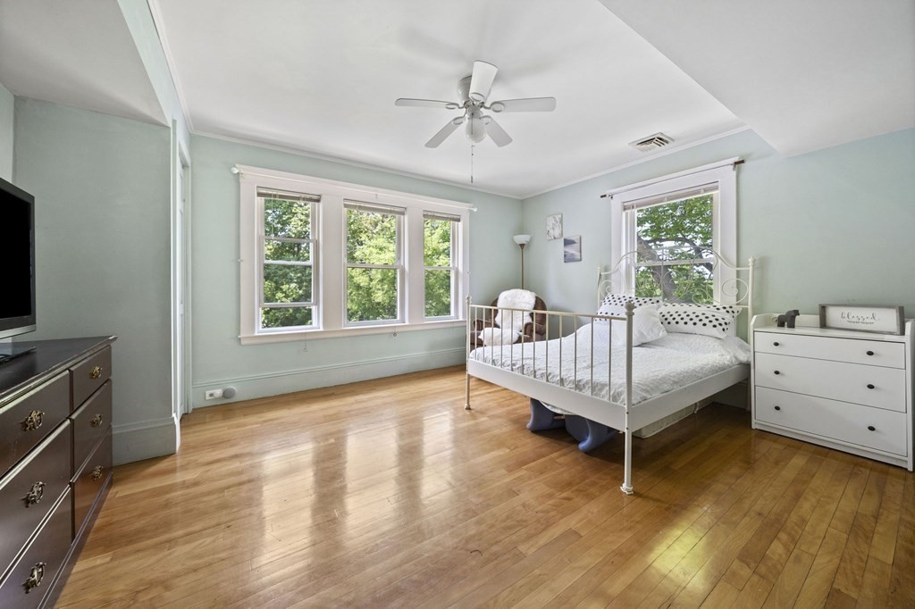 95 Monroe Road, Unit 2R Quincy, MA 02169 - Photo 11 of 19 a bedroom with a bed and a ceiling fan