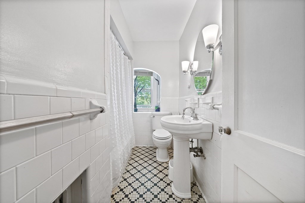 95 Monroe Road, Unit 2R Quincy, MA 02169 - Photo 12 of 19 a bathroom with a sink a toilet and a mirror