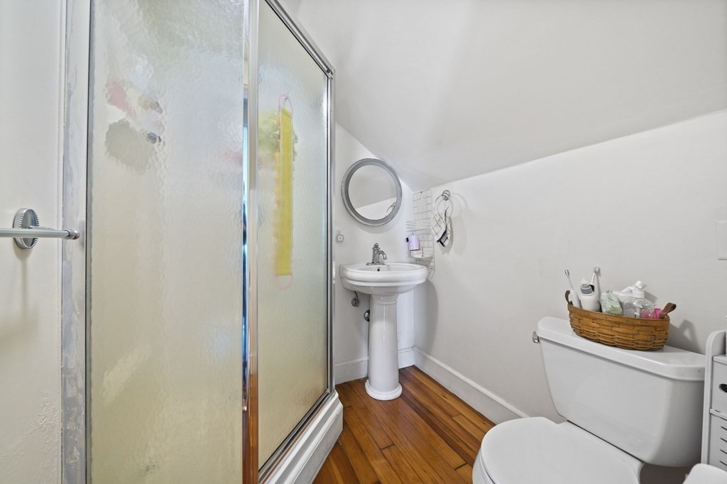 95 Monroe Road, Unit 2R Quincy, MA 02169 - Photo 15 of 19 a bathroom with a sink mirror vanity and toilet