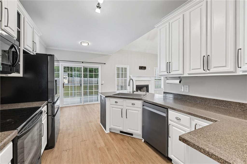4260 Mountain Ridge Road Gainesville, GA 30506 - Photo 14 of 39 a kitchen with stainless steel appliances granite countertop a stove a sink and a refrigerator