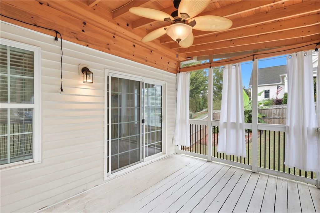 4260 Mountain Ridge Road Gainesville, GA 30506 - Photo 19 of 39 a view of a balcony with a ceiling fan and wooden floor