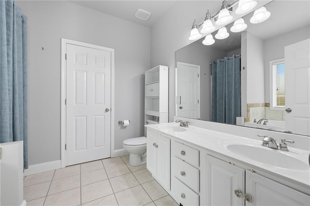 4260 Mountain Ridge Road Gainesville, GA 30506 - Photo 23 of 39 a bathroom with a sink a toilet and a mirror