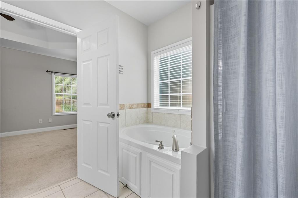 4260 Mountain Ridge Road Gainesville, GA 30506 - Photo 24 of 39 a bathroom with a tub sink and window