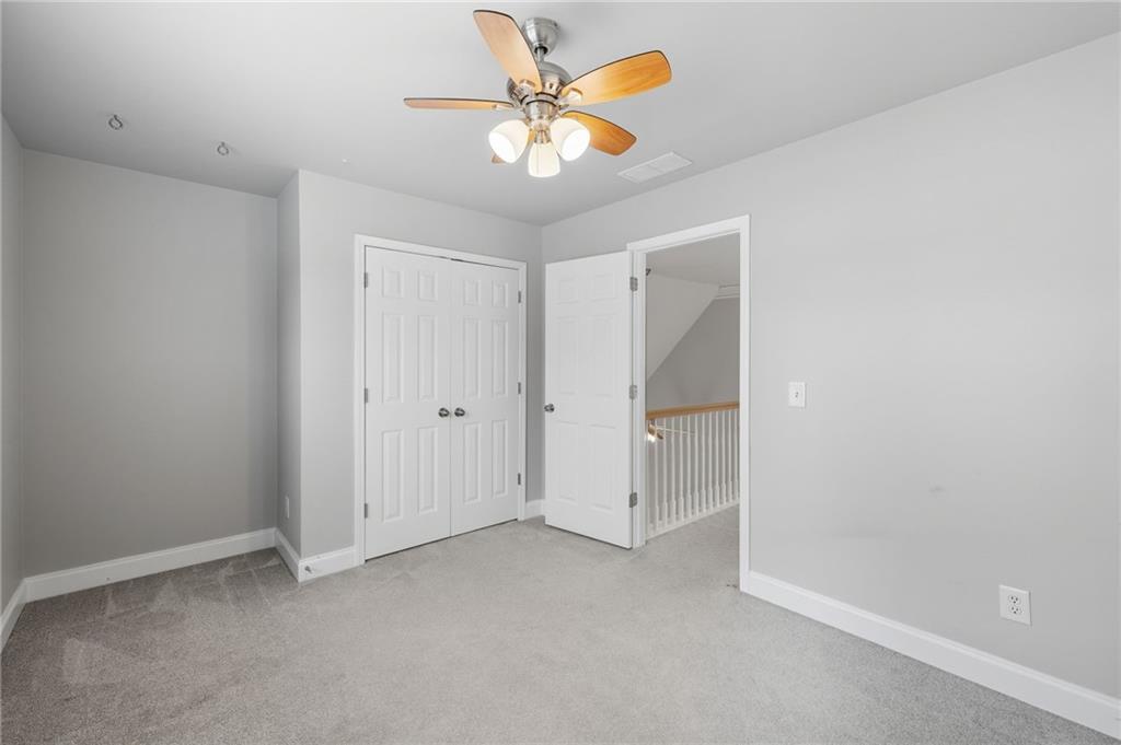4260 Mountain Ridge Road Gainesville, GA 30506 - Photo 37 of 39 an empty room with closet and fan