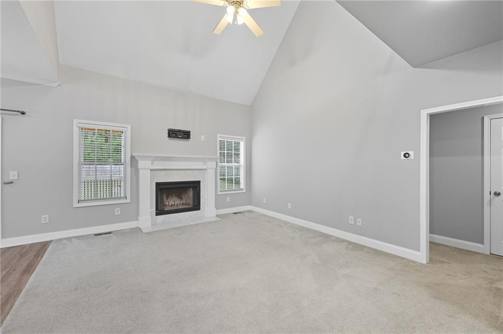 4260 Mountain Ridge Road Gainesville, GA 30506 - Photo 7 of 39 an empty room with windows and fireplace