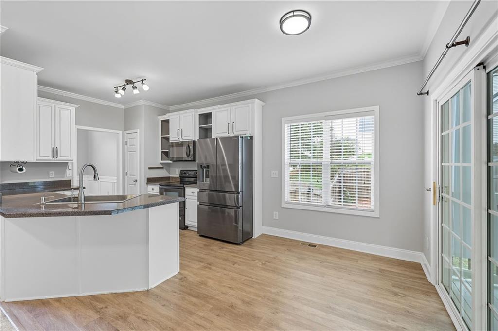 4260 Mountain Ridge Road Gainesville, GA 30506 - Photo 10 of 39 a kitchen with stainless steel appliances granite countertop a refrigerator and a stove top oven
