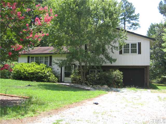 8341 Ebenezer Church Road Raleigh, NC 27617 - Photo 1 of 3 a front view of a house with a yard