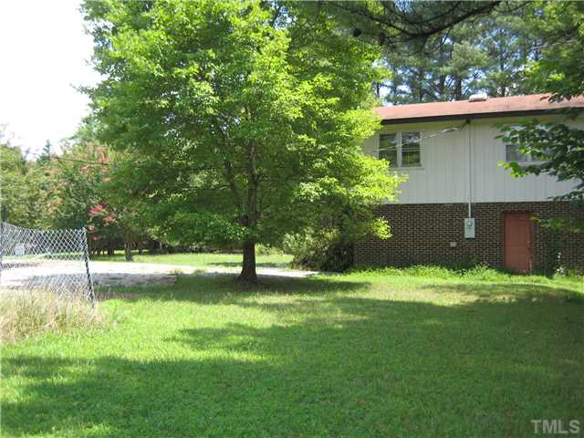 8341 Ebenezer Church Road Raleigh, NC 27617 - Photo 3 of 3 a view of a backyard with a tree