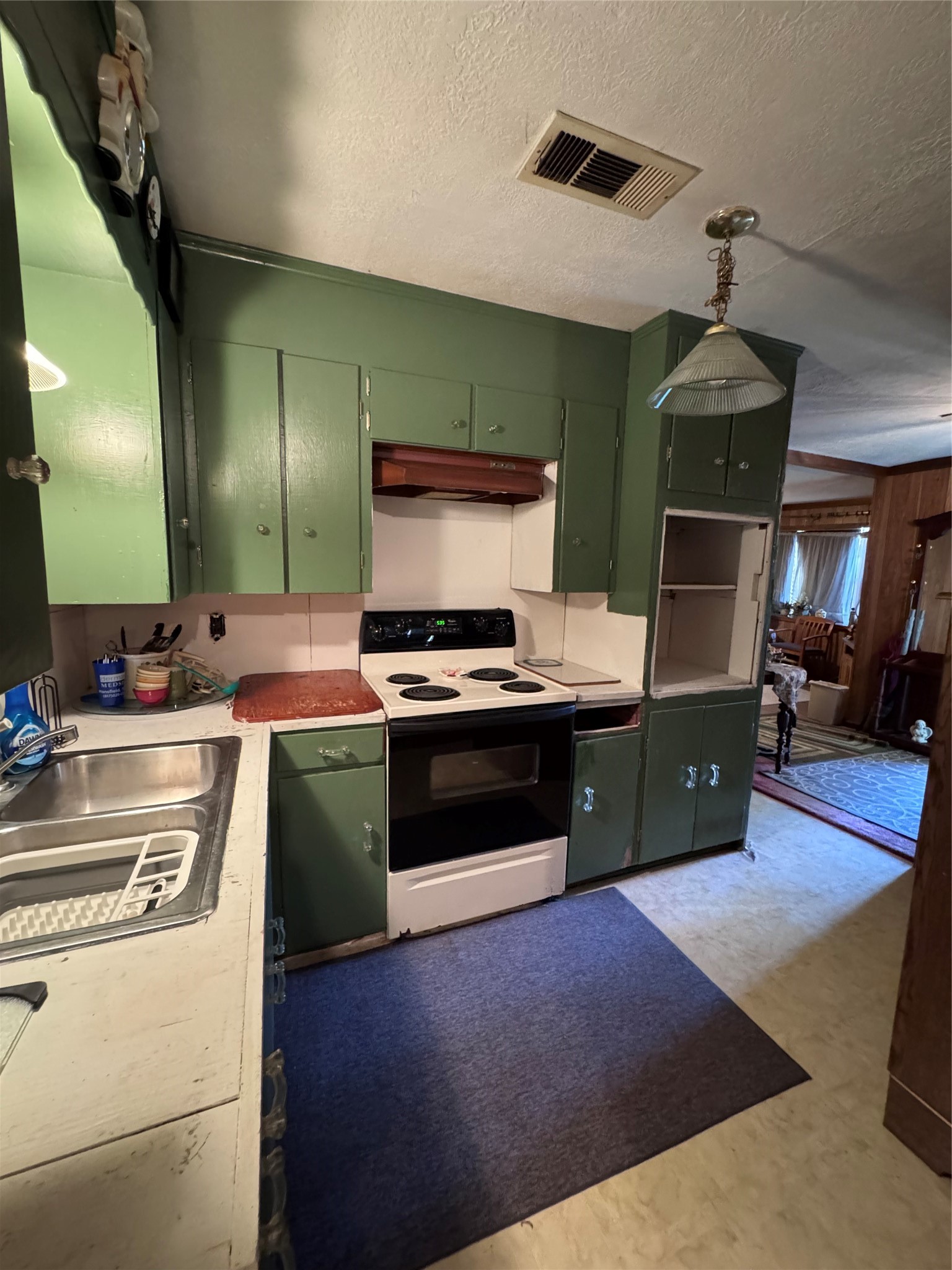479 County Road Goodrich, TX 77335 - Photo 6 of 16 a kitchen with stainless steel appliances kitchen island granite countertop a stove a sink and a microwave