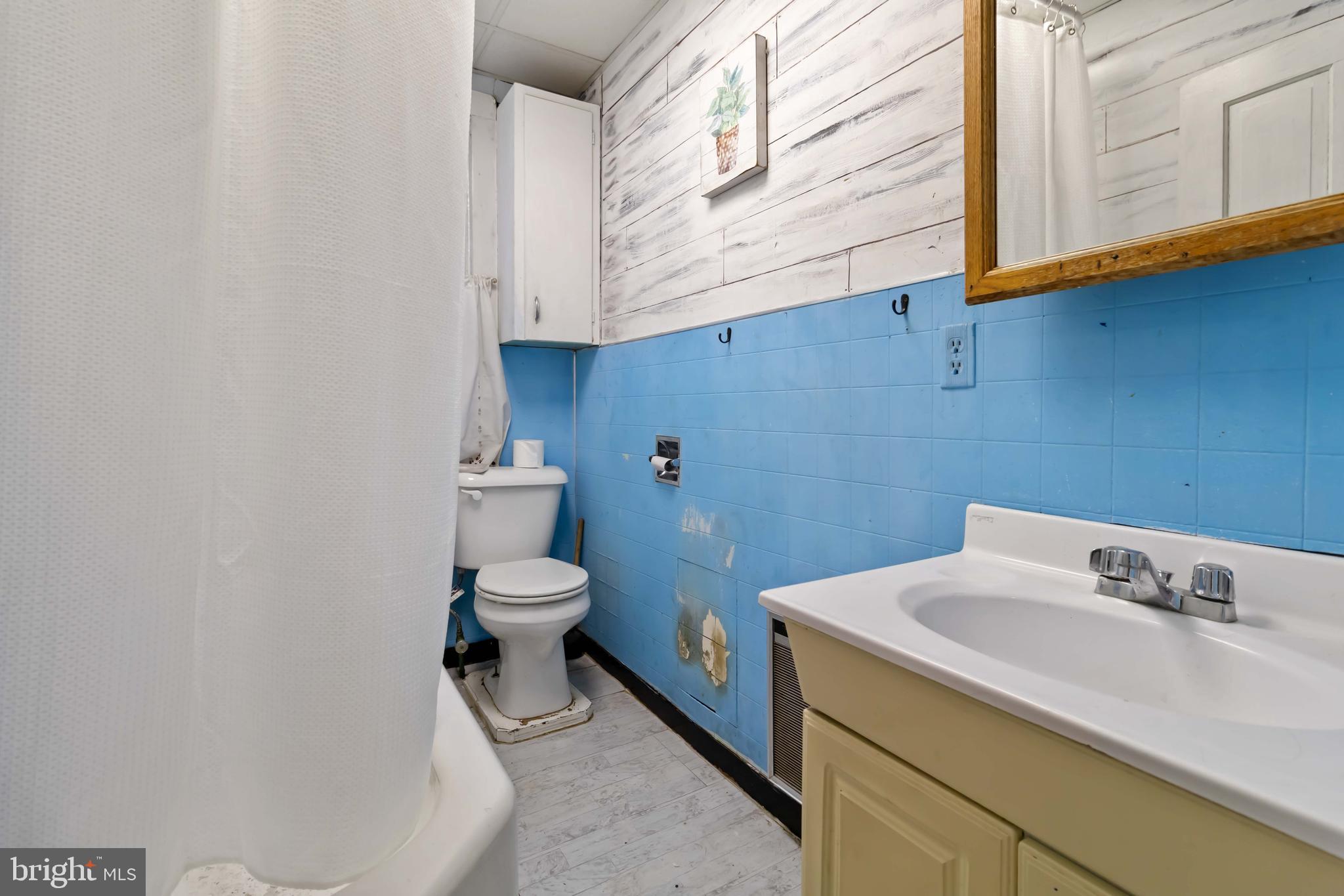 11 West Commerce Street Shamokin, PA 17872 - Photo 15 of 24 a bathroom with a sink a toilet and a mirror