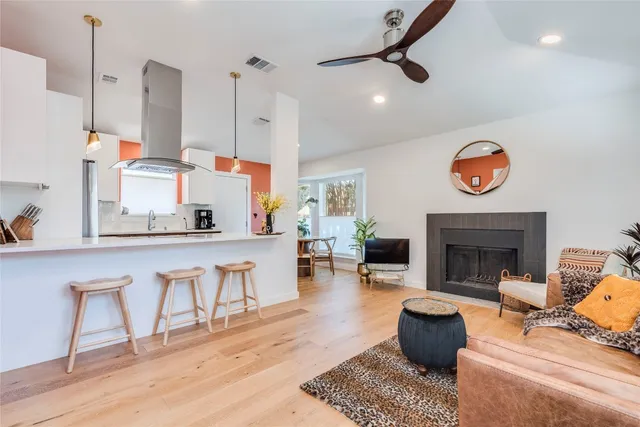 a living room with patio furniture and a fireplace