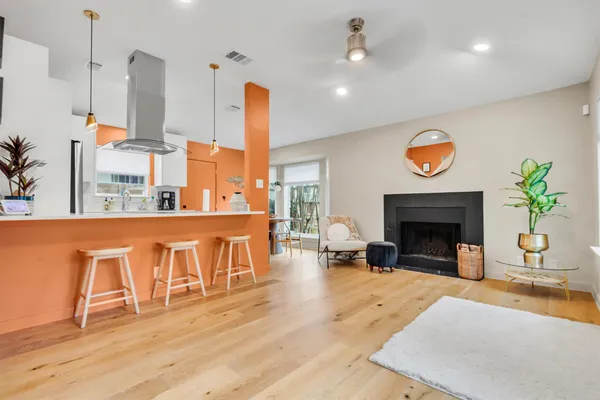 a living room with furniture a fireplace and next to a window