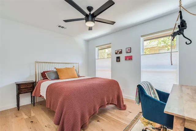 a bedroom with a bed couch and a window