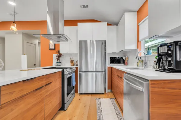 a kitchen with granite countertop stainless steel appliances a sink and counter space
