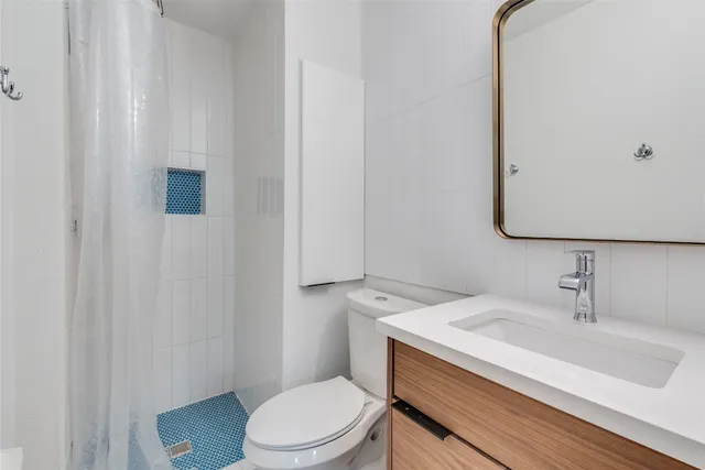 a bathroom with a sink toilet and vanity