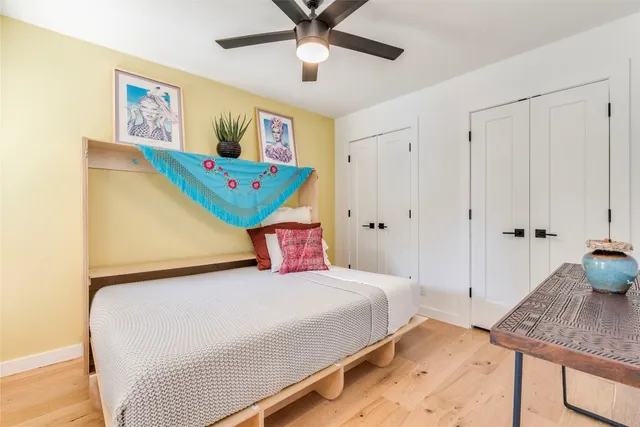 a bedroom with a bed and a chandelier