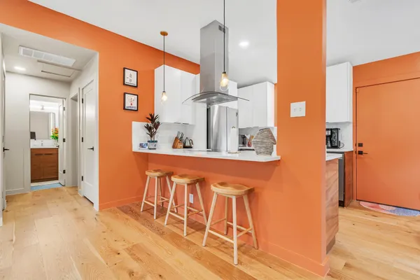 a dining table chairs next to a window
