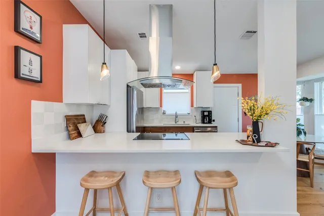 a kitchen with a table chairs and a stove