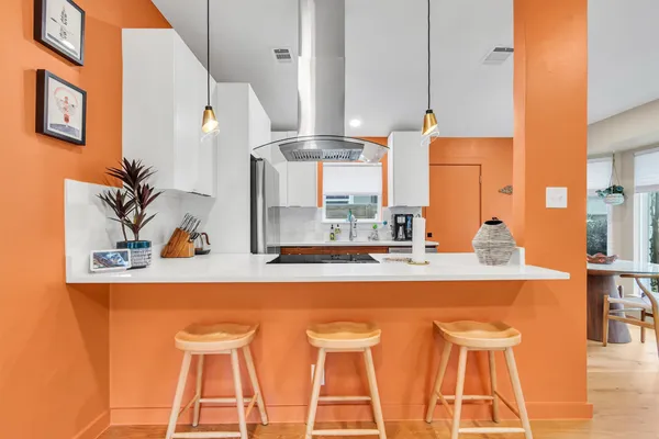 a large kitchen with a table and chairs