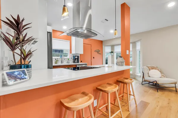 a kitchen with stainless steel appliances granite countertop a refrigerator a stove and a sink