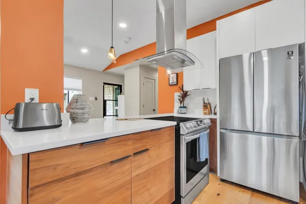 a kitchen with stainless steel appliances a refrigerator and a sink