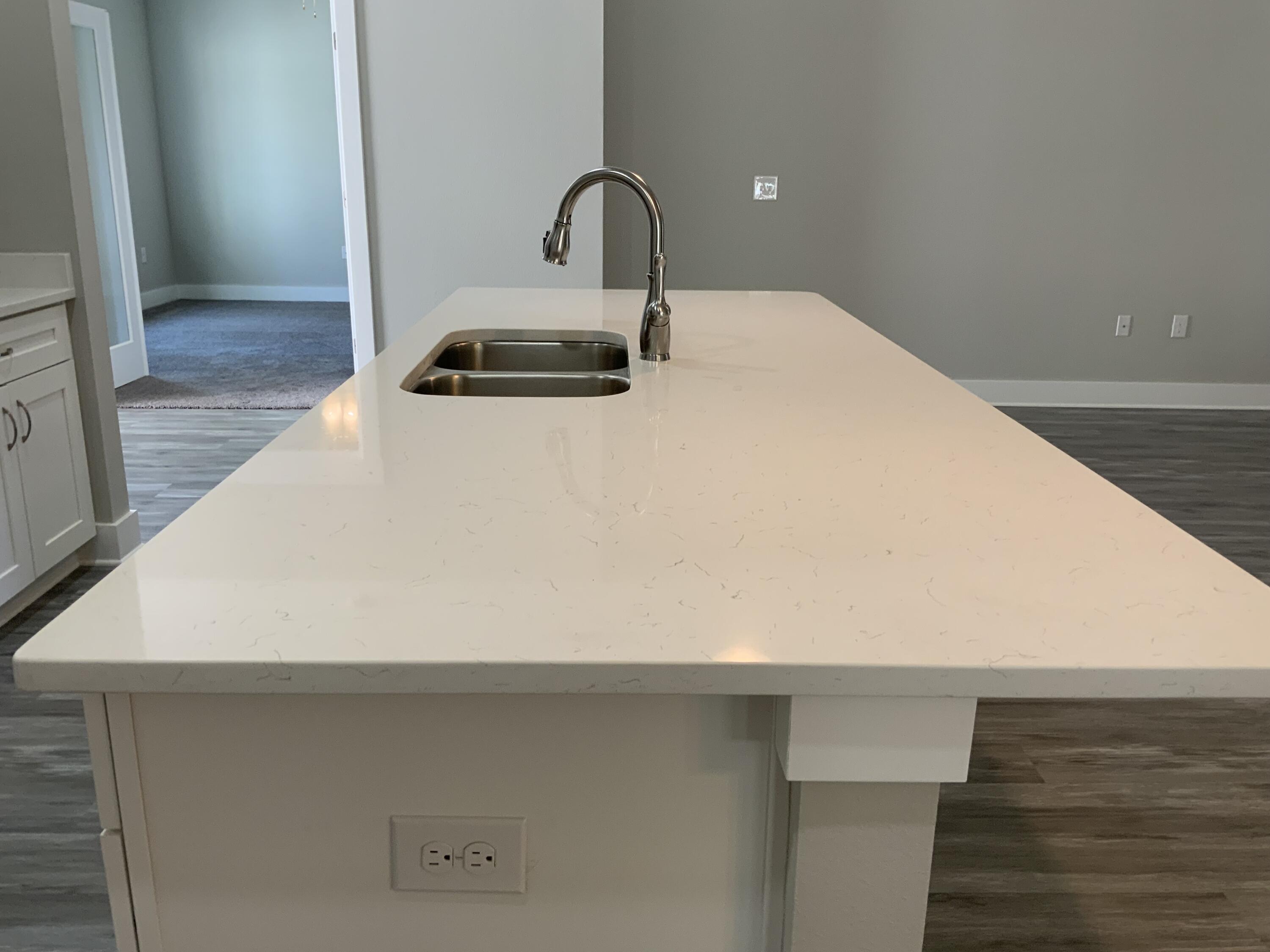 a close view of a sink and dishwasher in a kitchen