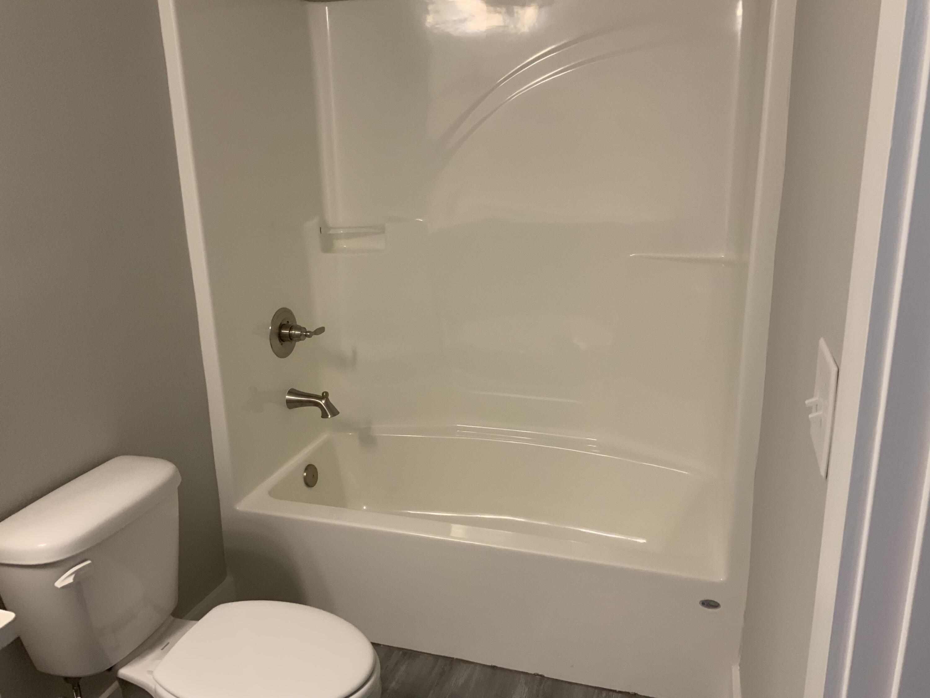 2800 Ram Lane Crestview, FL 32539 - Photo 12 of 20 a white toilet sitting next to a bath tub