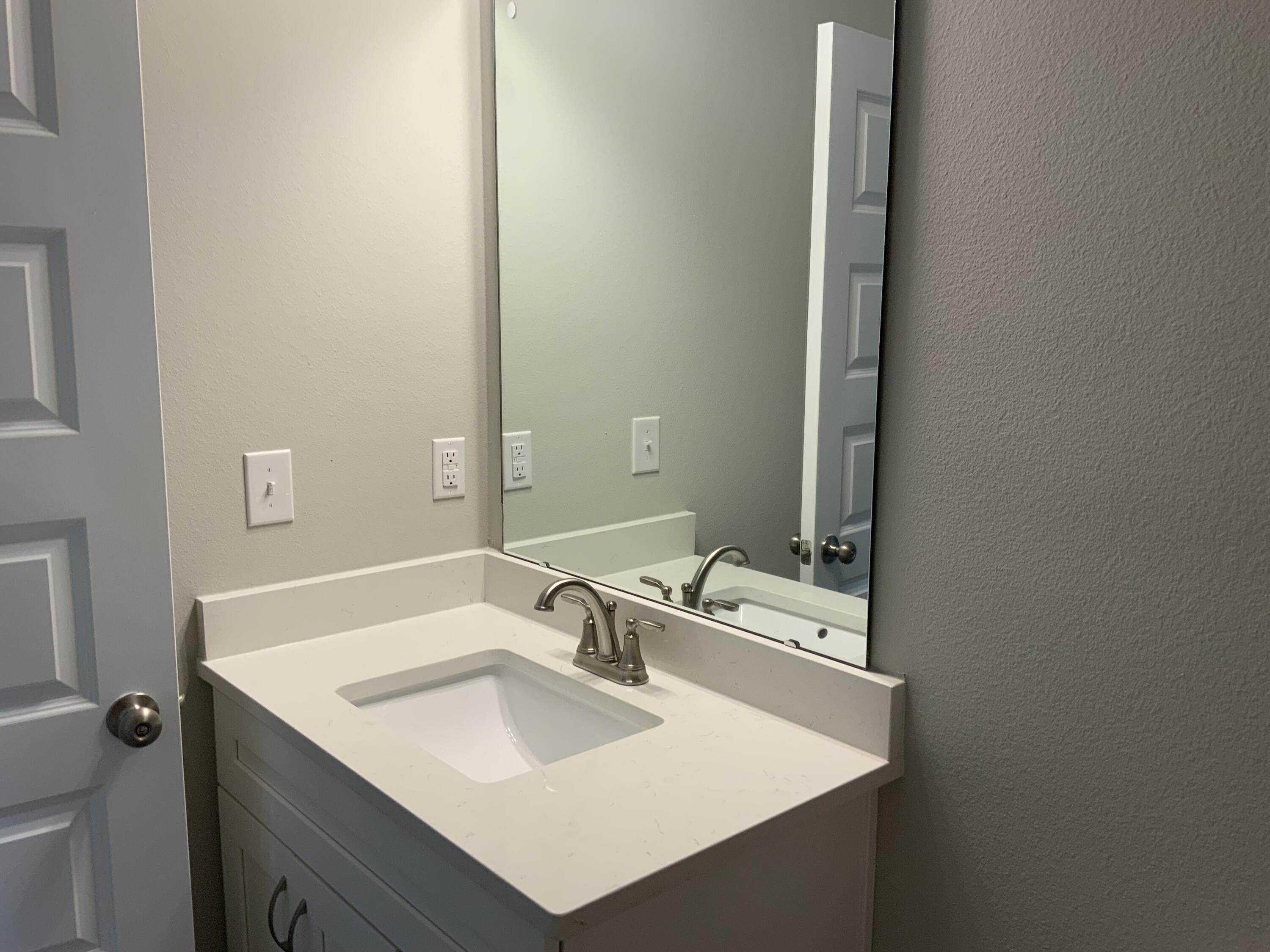 2800 Ram Lane Crestview, FL 32539 - Photo 13 of 20 a bathroom with a sink and a mirror