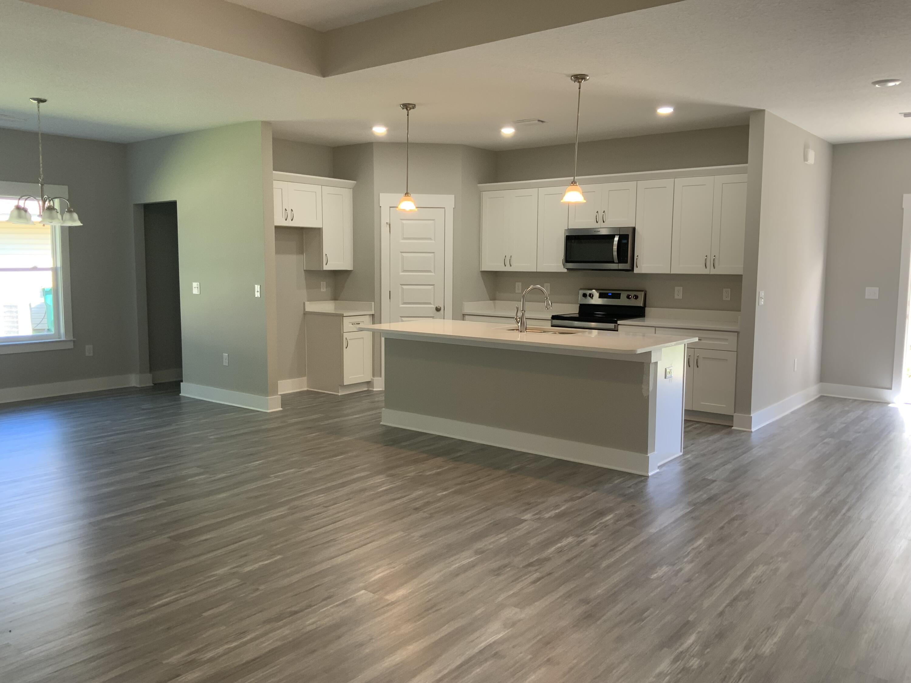 2800 Ram Lane Crestview, FL 32539 - Photo 2 of 20 a view of kitchen with stainless steel appliances wooden floor and large window