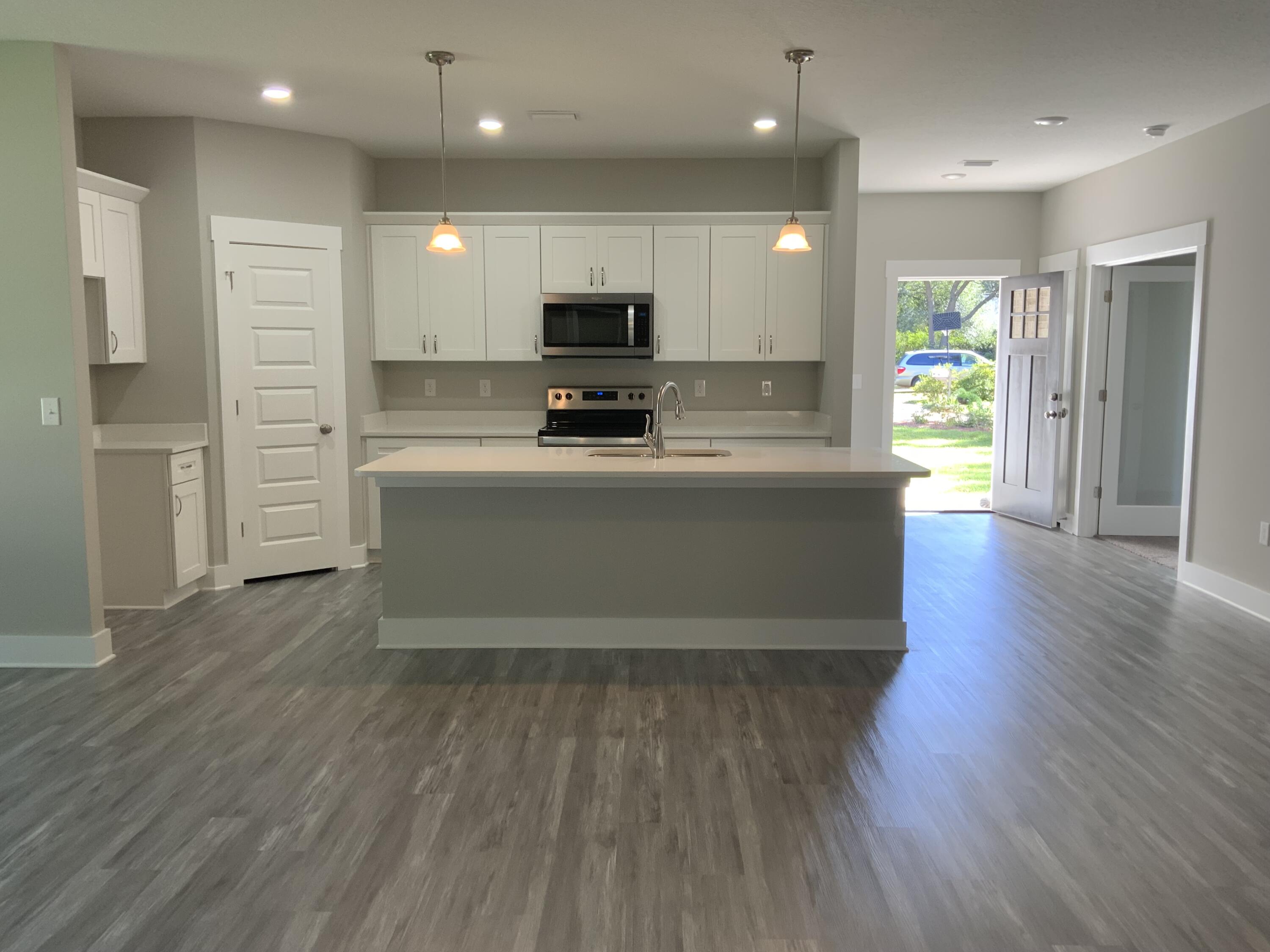 2800 Ram Lane Crestview, FL 32539 - Photo 3 of 20 a large kitchen with stainless steel appliances refrigerator a stove and wooden floor