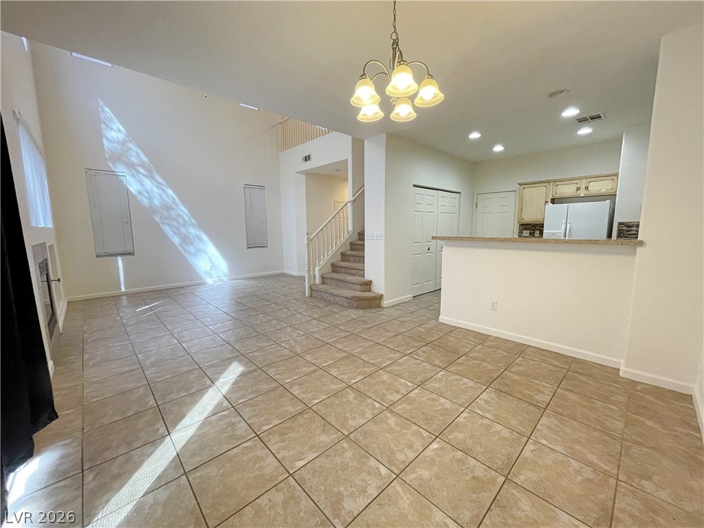 691 Principle Point Avenue Henderson, NV 89012 - Photo 11 of 30 A spacious living area with soaring vaulted ceilings and ceramic tile flooring awaits your personal touch.