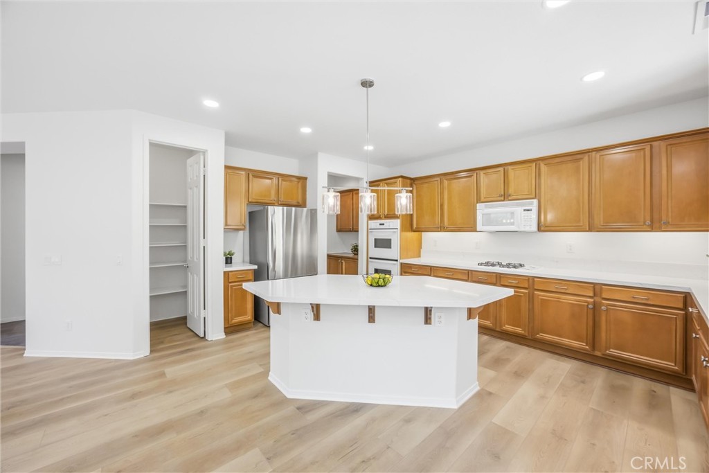 8710 Windmill Place Riverside, CA 92508 - Photo 17 of 66 a view of a kitchen with stainless steel appliances granite countertop a sink and dishwasher a refrigerator with wooden floor