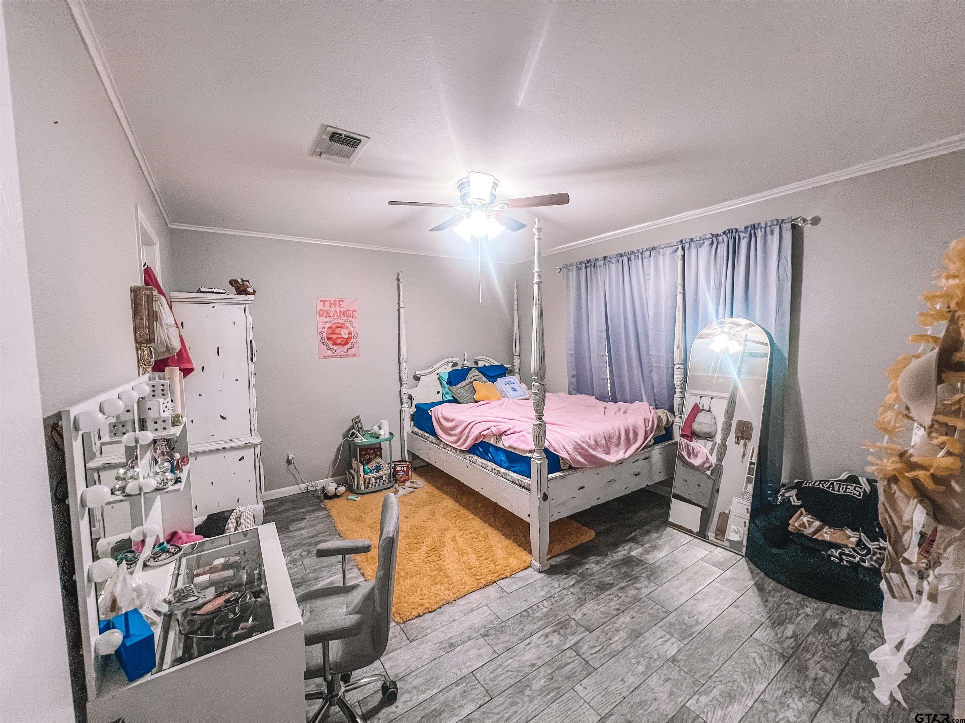 648 Daingerfield Street Pittsburg, TX 75686 - Photo 17 of 27 a bedroom with furniture and a bed