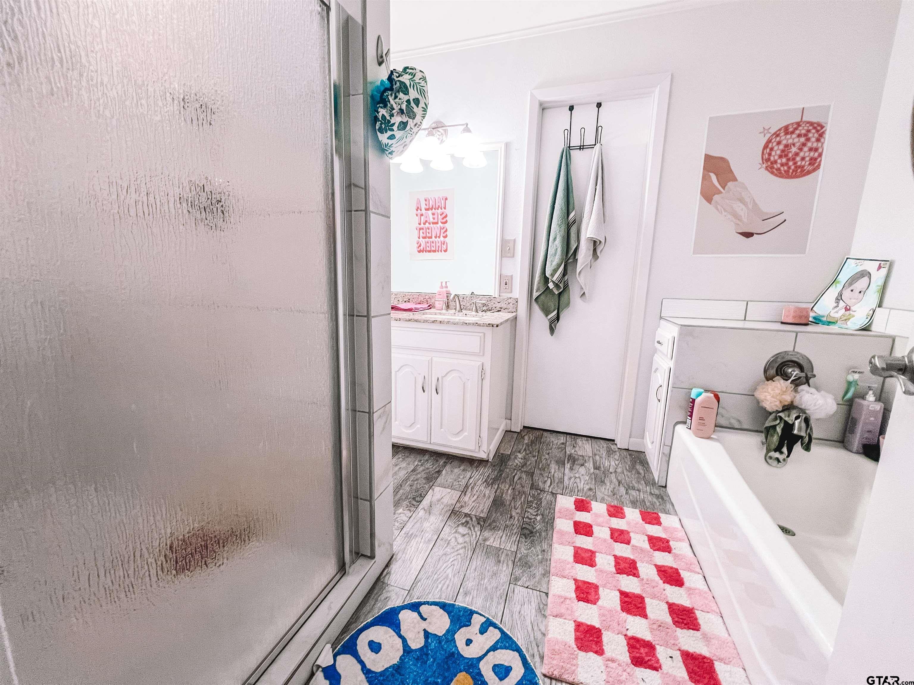 648 Daingerfield Street Pittsburg, TX 75686 - Photo 18 of 27 a bathroom with a sink and a shower curtain