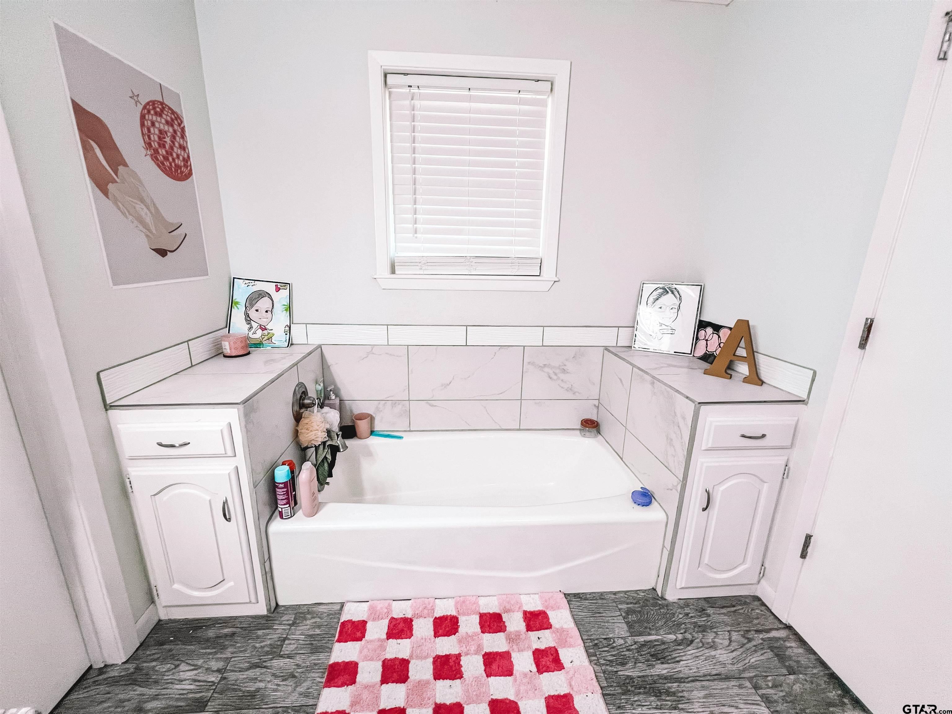 648 Daingerfield Street Pittsburg, TX 75686 - Photo 21 of 27 a bathroom with a sink and a bathtub