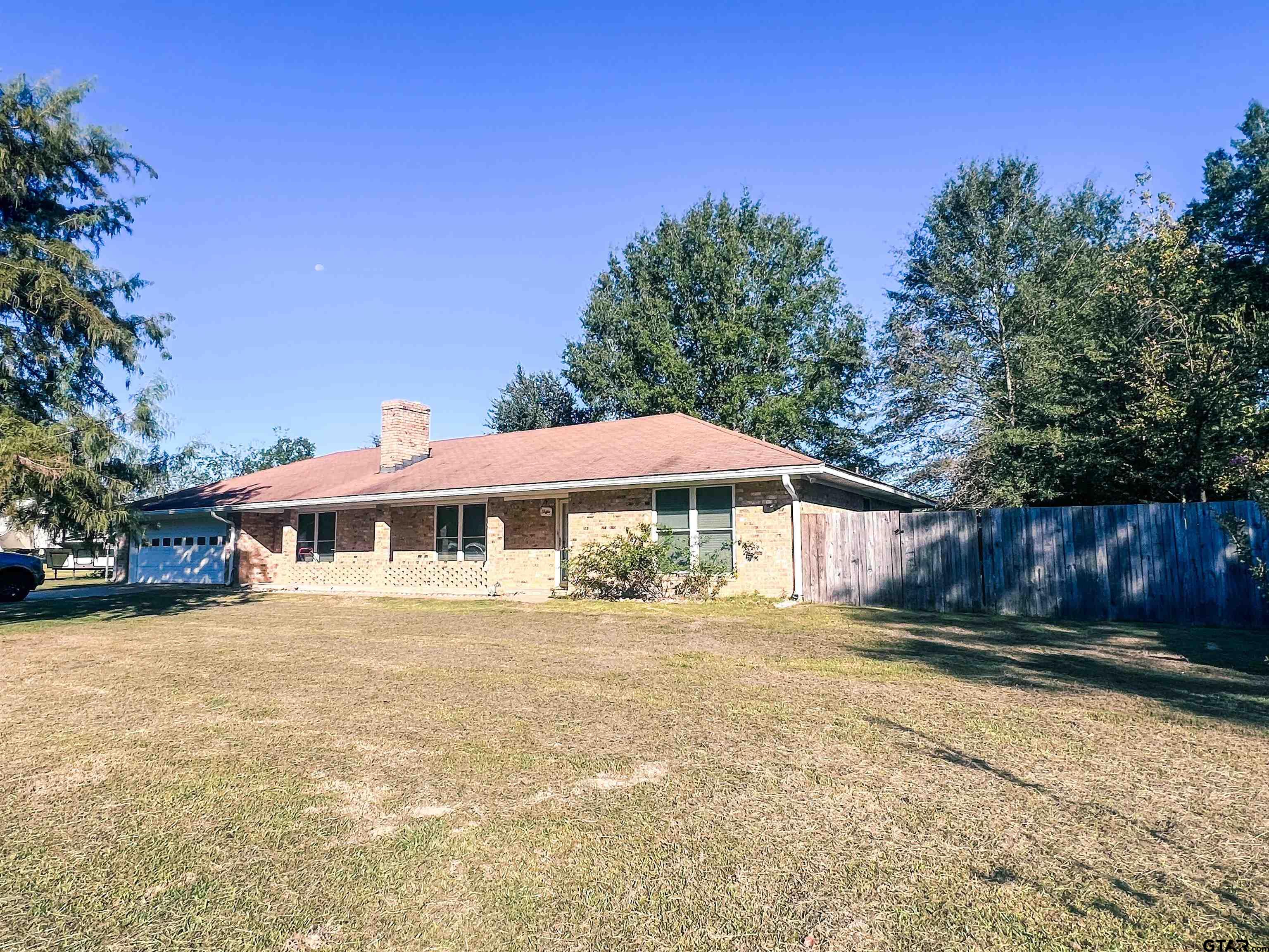 648 Daingerfield Street Pittsburg, TX 75686 - Photo 27 of 27 a front view of a house with yard and trees