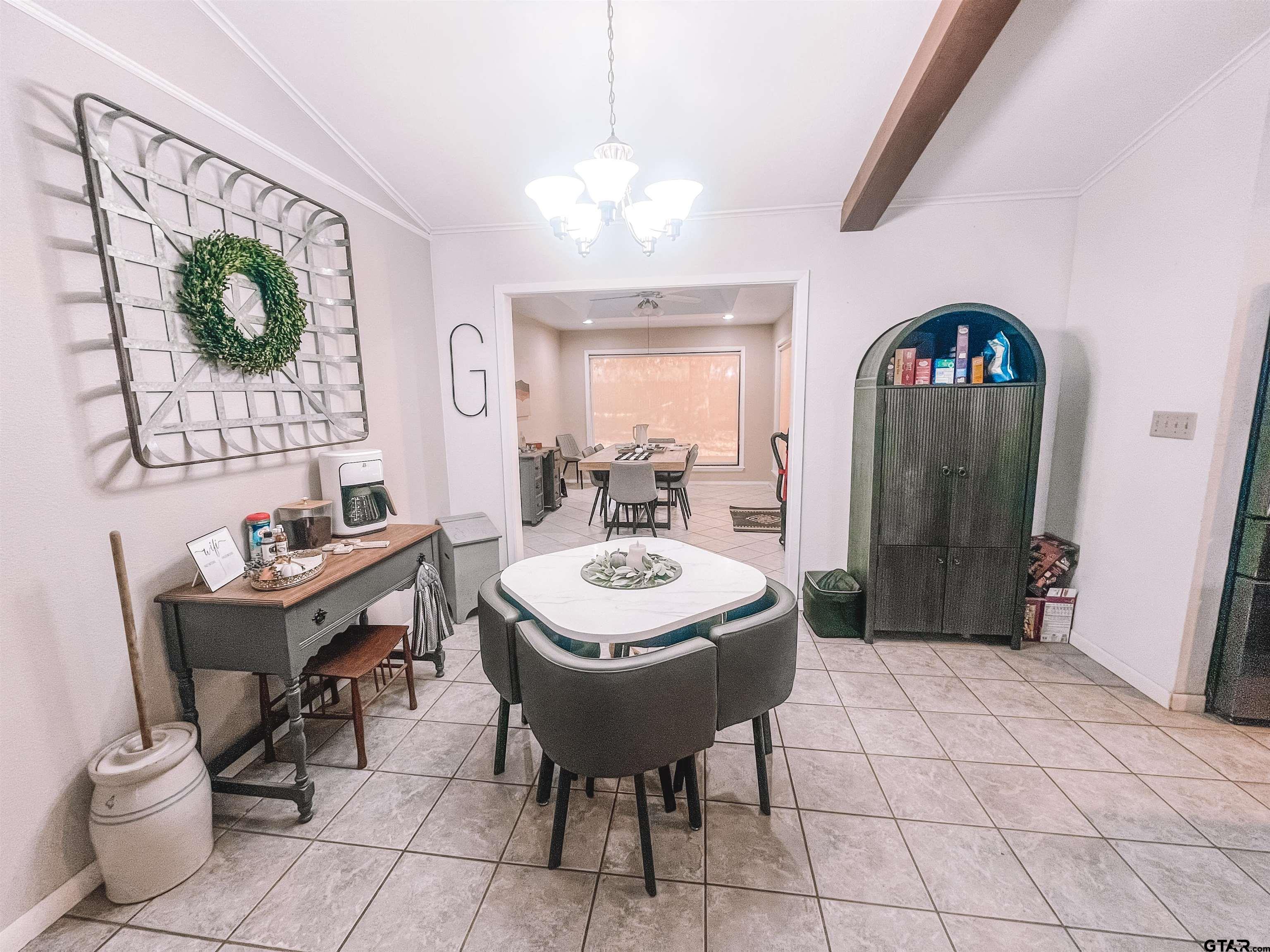 648 Daingerfield Street Pittsburg, TX 75686 - Photo 10 of 27 a view of a dining room with furniture and a chandelier