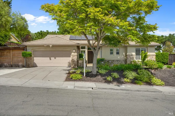 front view of a house with a bench