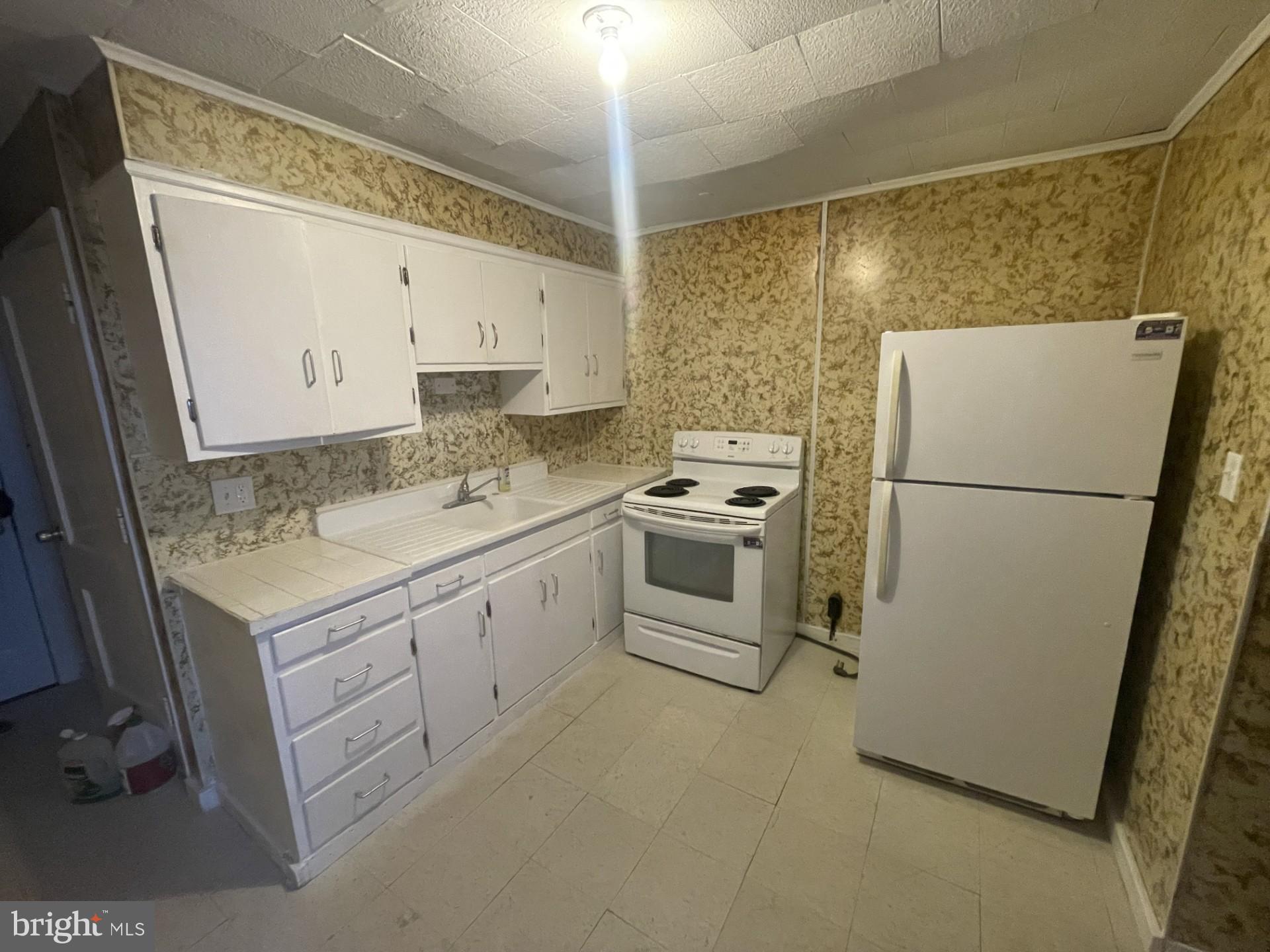 932 Walnut Street Reading, PA 19601 - Photo 2 of 13 a utility room with cabinets washer and dryer