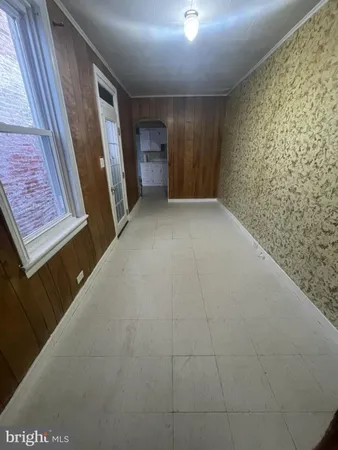 a view of an empty room and a bathroom