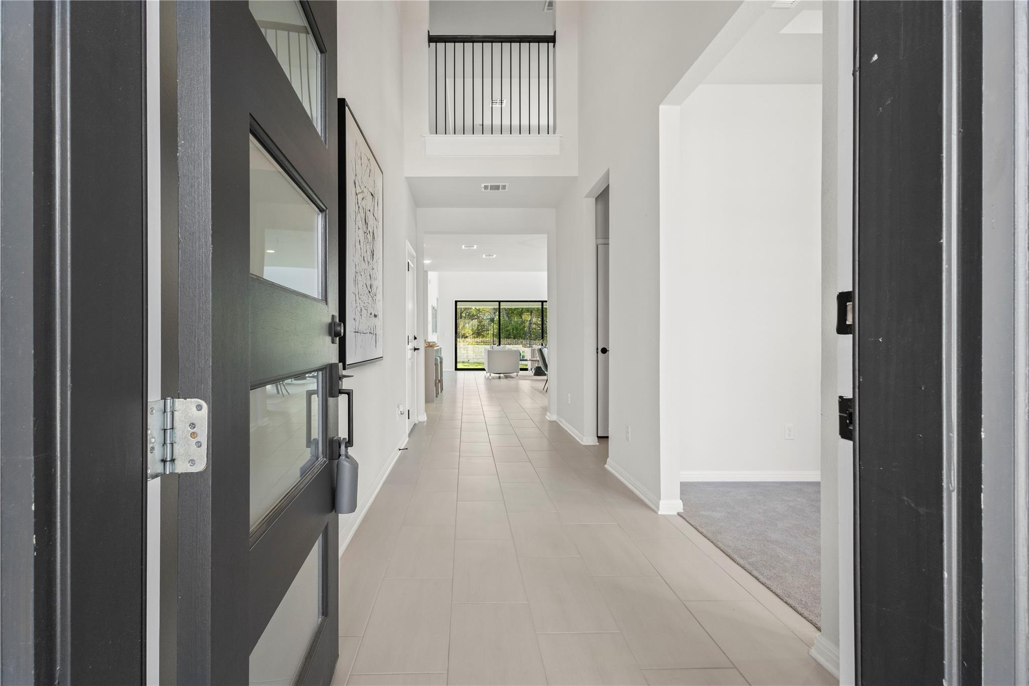 1128 Villa Rialto View Leander, TX 78641 - Photo 6 of 40 Corridor with a high ceiling and light tile patterned floors