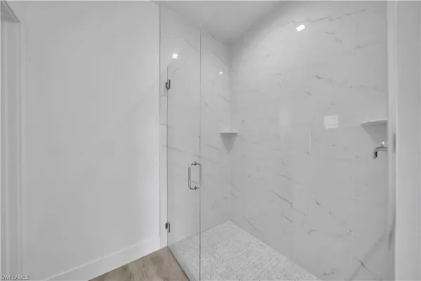 a white toilet sitting next to a bathroom sink and vanity