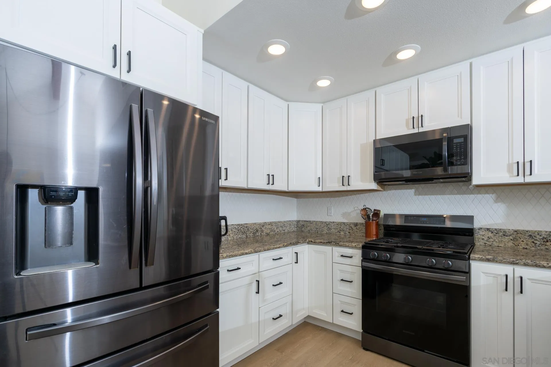 10354 Settle Road Santee, CA 92071 - Photo 13 of 56 a kitchen with stainless steel appliances and white cabinets