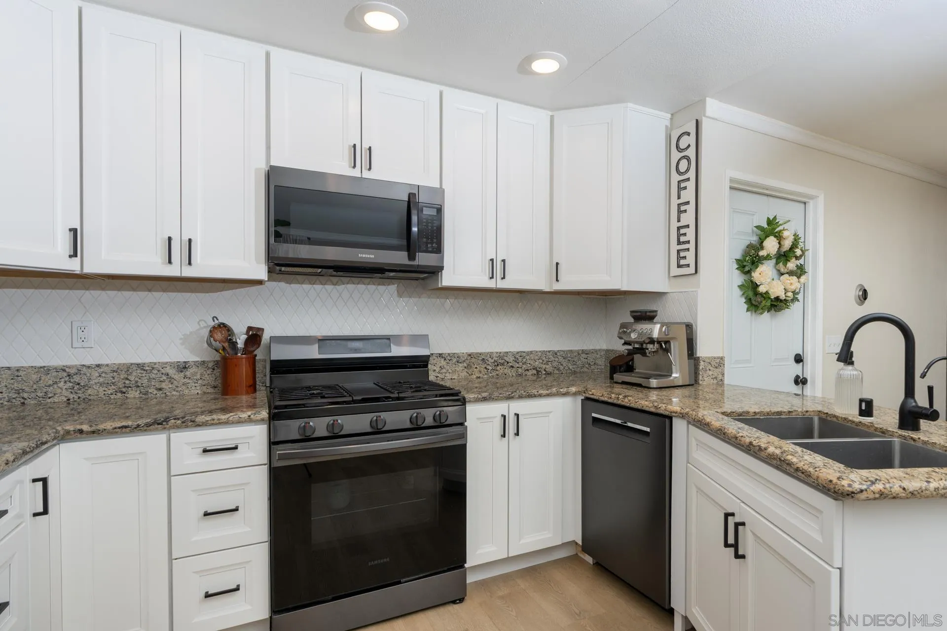 10354 Settle Road Santee, CA 92071 - Photo 14 of 56 a kitchen with granite countertop white cabinets and stainless steel appliances