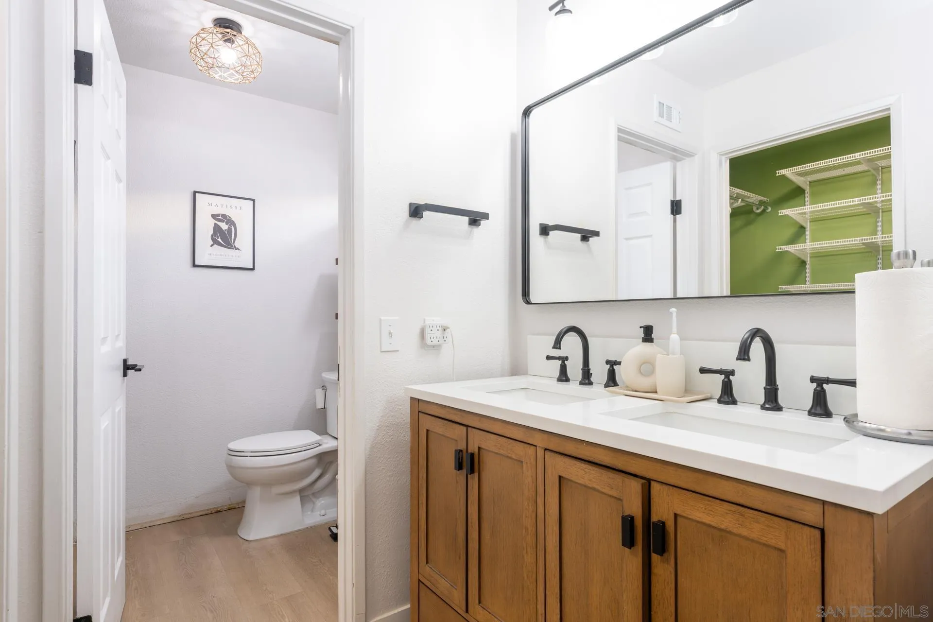 10354 Settle Road Santee, CA 92071 - Photo 19 of 56 a bathroom with a granite countertop sink toilet and mirror