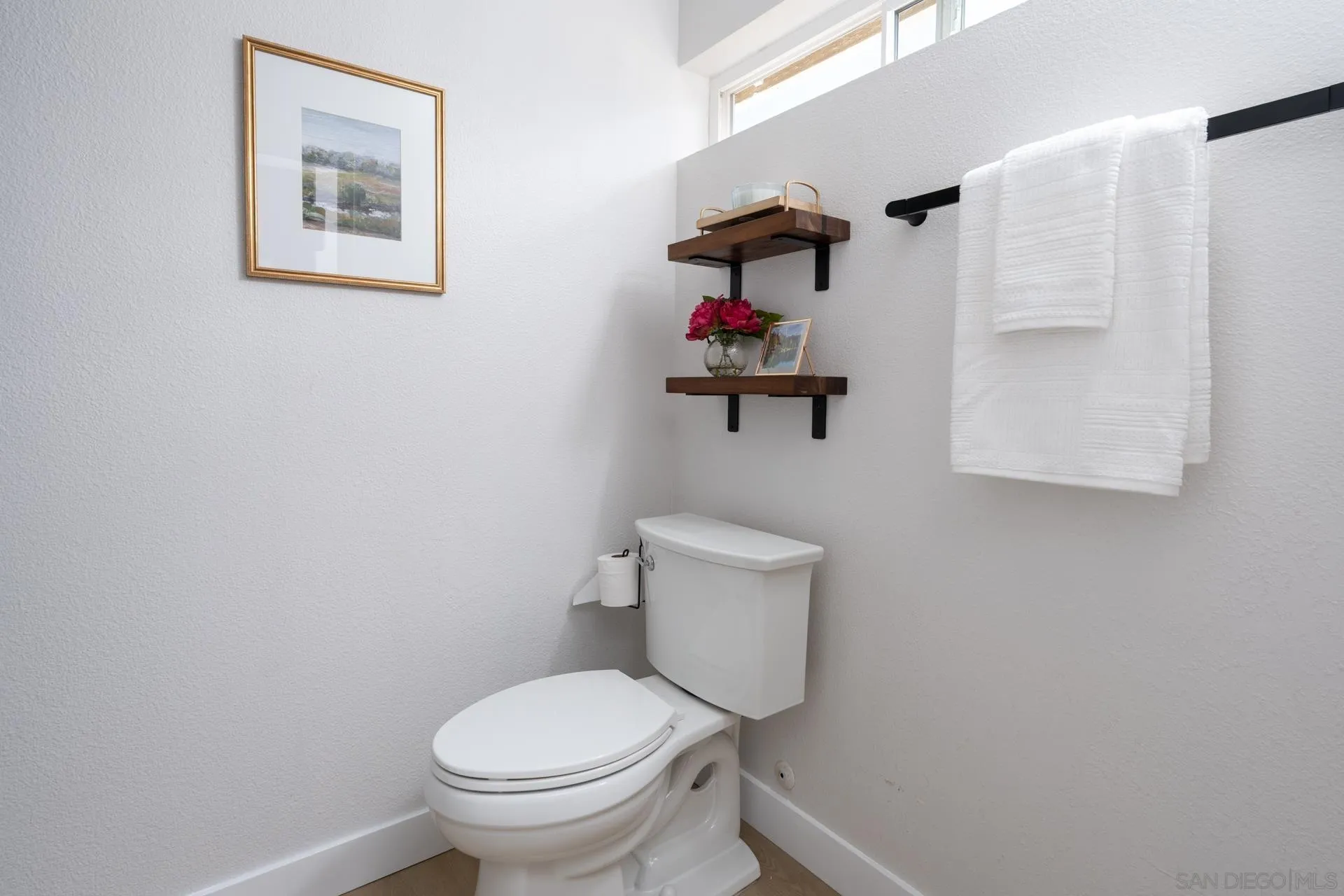 10354 Settle Road Santee, CA 92071 - Photo 21 of 56 a white toilet sitting next to a bathroom sink